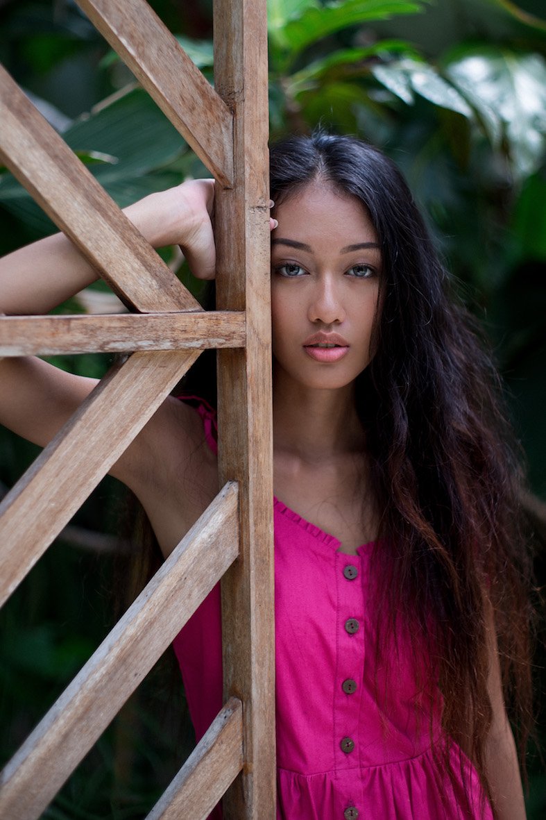 Balistarz-model-Claudia-Maretha-Pink-dress-leaning-on-wooden-fence